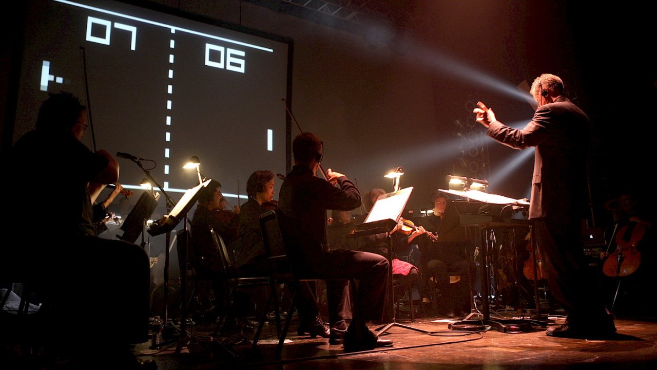 video game concerts austin wintory journey interview - a close up image of the stage as the orchestra at a Video Games Live show perform music related to Pong